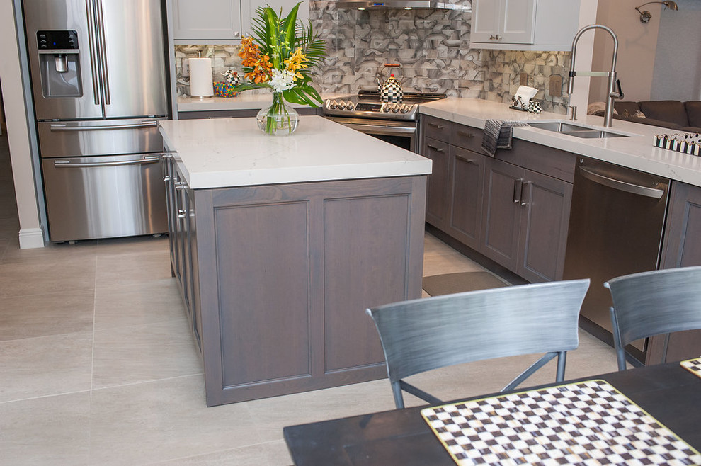 Eat-in kitchen - mid-sized transitional u-shaped porcelain tile and beige floor eat-in kitchen idea in Miami with an undermount sink, shaker cabinets, gray cabinets, quartz countertops, gray backsplash, glass tile backsplash, stainless steel appliances, an island and white countertops