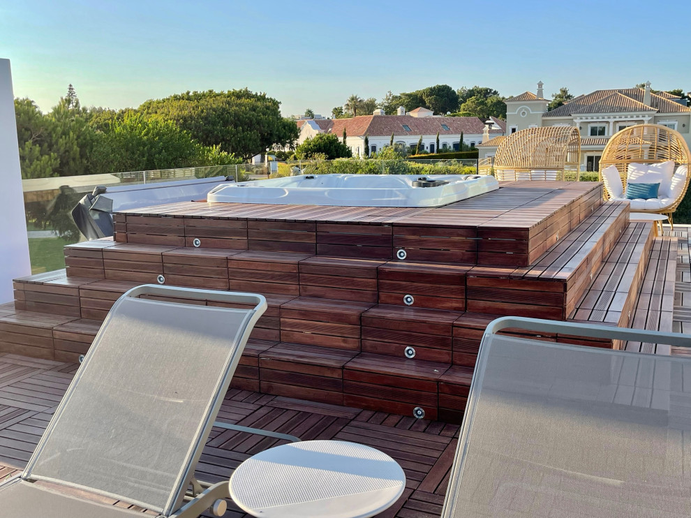 Photo of a large modern roof rooftop glass railing terrace in West Midlands with a bar area and no cover.
