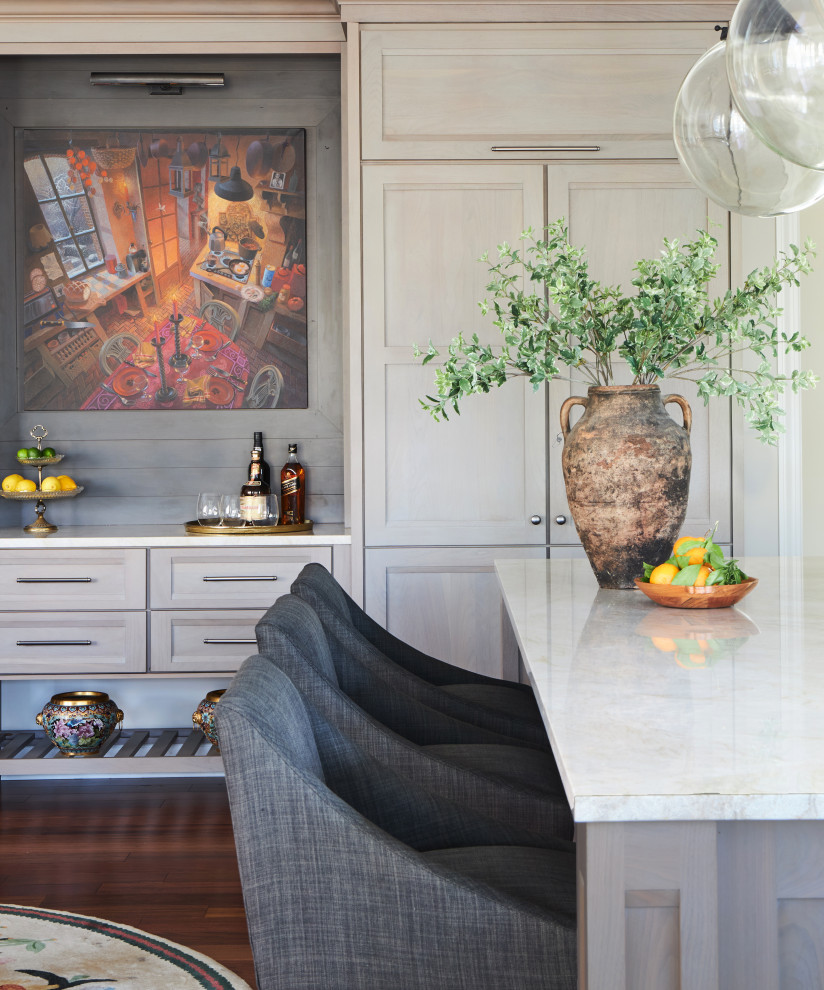 Inspiration for a large transitional l-shaped kitchen pantry remodel in Chicago with an undermount sink, flat-panel cabinets, medium tone wood cabinets, quartzite countertops, beige backsplash, stone tile backsplash, paneled appliances, an island and white countertops