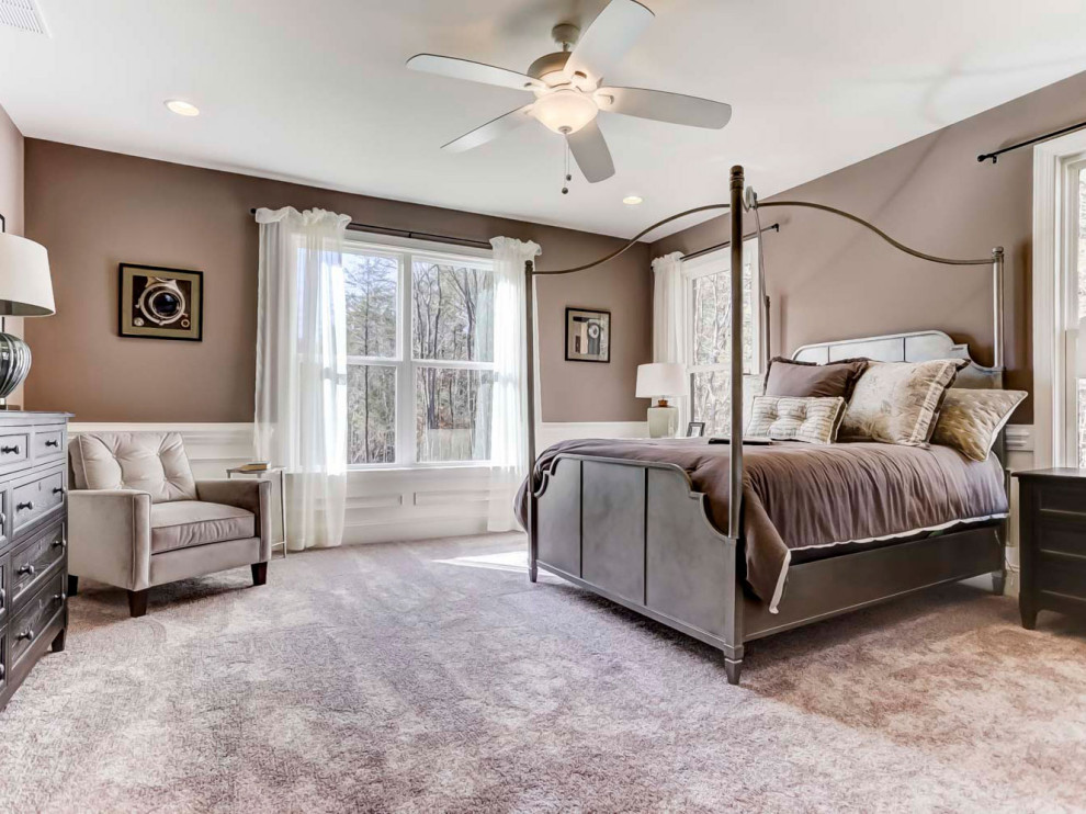 Large bedroom in Charlotte with beige walls, carpet, purple floor and decorative wall panelling.