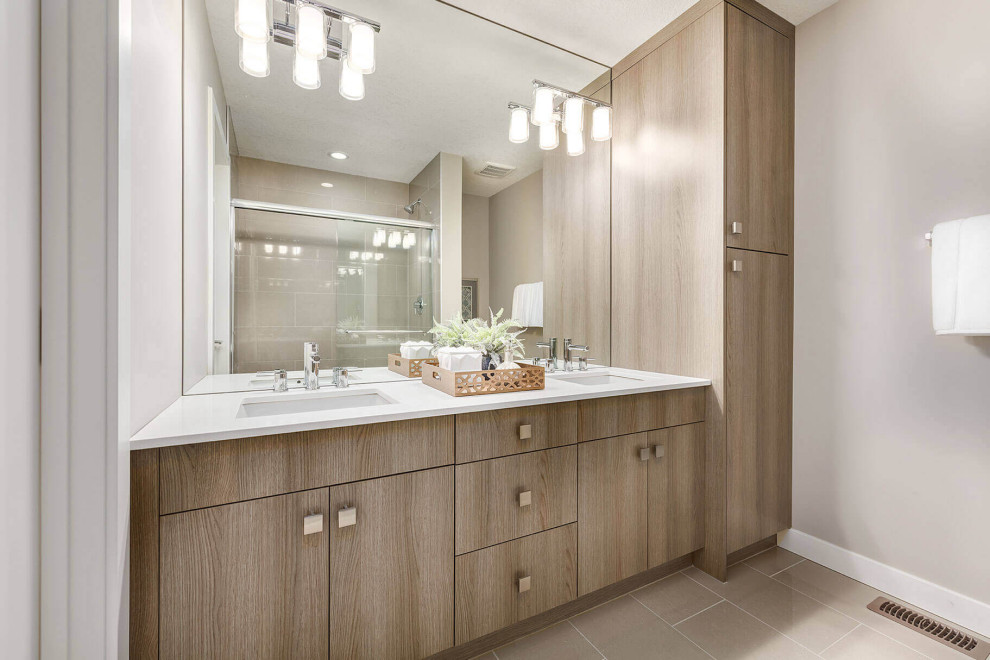 Medium sized midcentury bathroom in Calgary with flat-panel cabinets, a submerged bath, beige walls, porcelain flooring, a submerged sink, engineered stone worktops, brown floors, white worktops, an enclosed toilet, double sinks and a built in vanity unit.