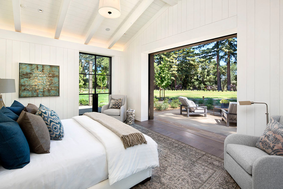 Photo of a mid-sized country master bedroom in San Francisco with white walls, medium hardwood floors and brown floor.