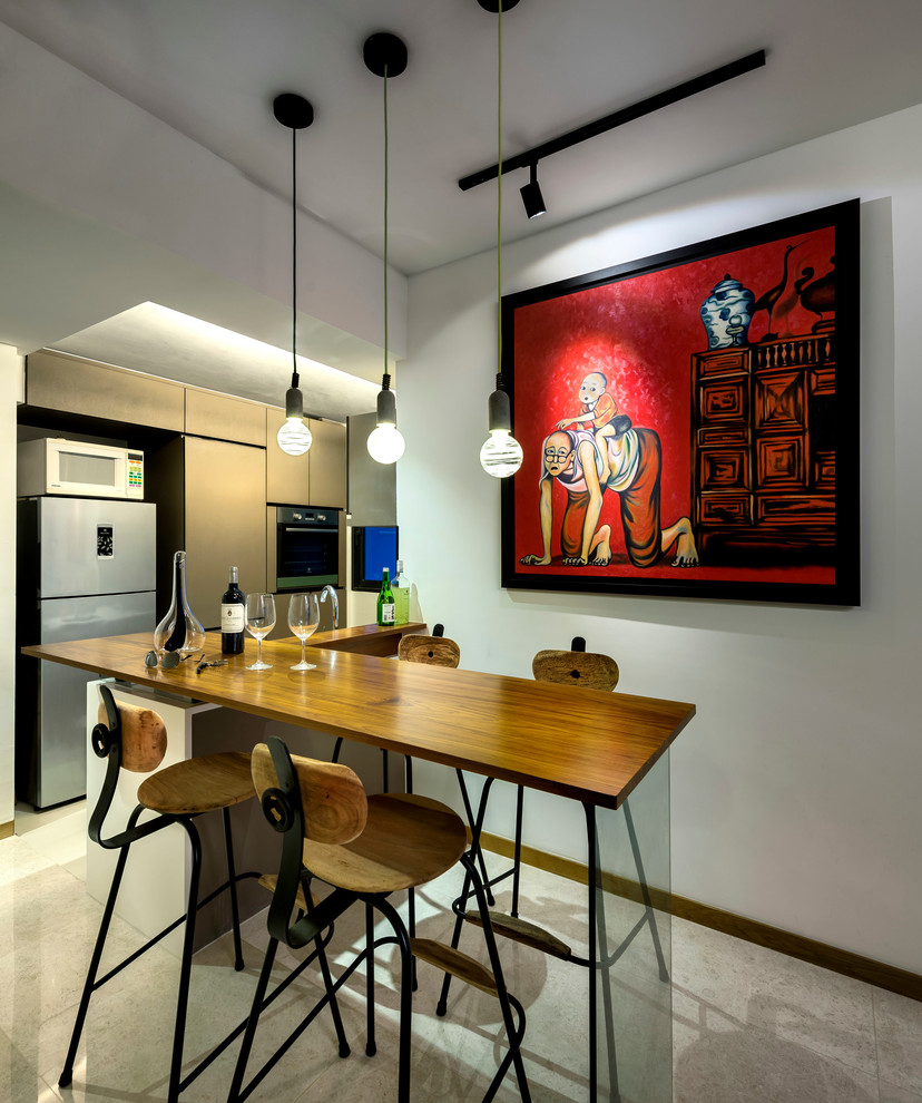 Photo of a small eclectic l-shaped seated home bar in Singapore with flat-panel cabinets, beige cabinets, quartz benchtops, black splashback and marble floors.