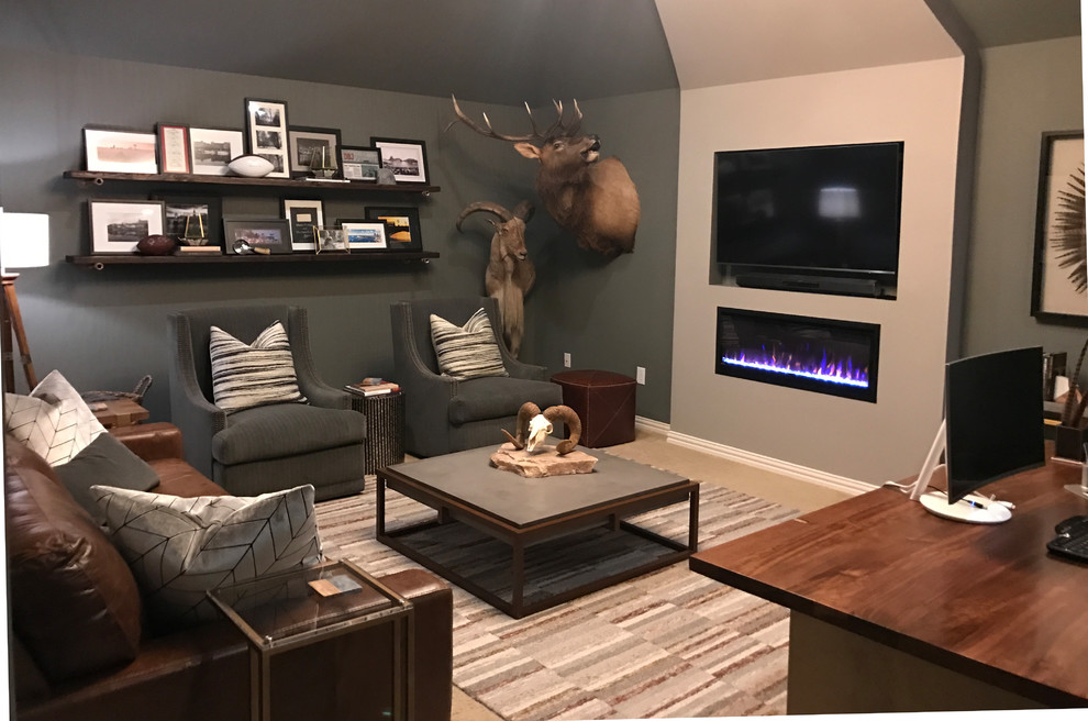 Photo of a mid-sized country study room in Dallas with grey walls, carpet, a hanging fireplace, a freestanding desk and beige floor.