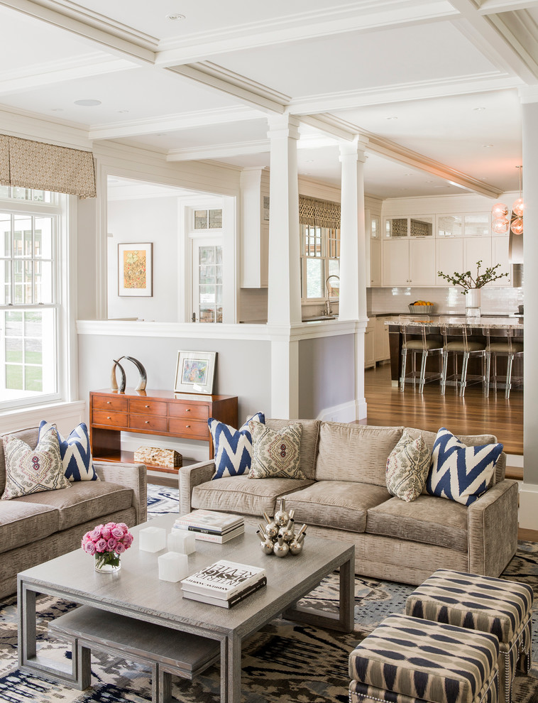 This is an example of a traditional open concept living room in Boston with grey walls.