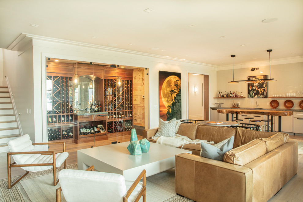 This is an example of a large beach style open concept family room in Other with a game room, white walls, light hardwood floors, a standard fireplace, a stone fireplace surround, a wall-mounted tv and brown floor.