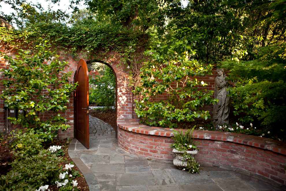 Design ideas for a mid-sized traditional backyard formal garden in San Francisco with natural stone pavers.