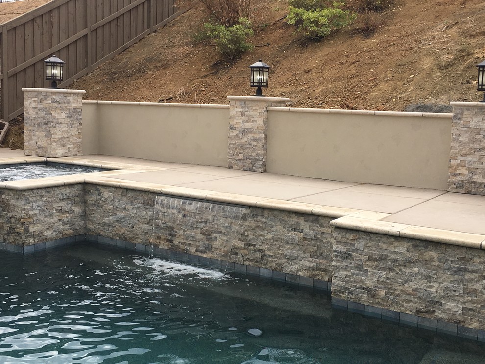 Small contemporary backyard rectangular pool in Sacramento with a hot tub and stamped concrete.