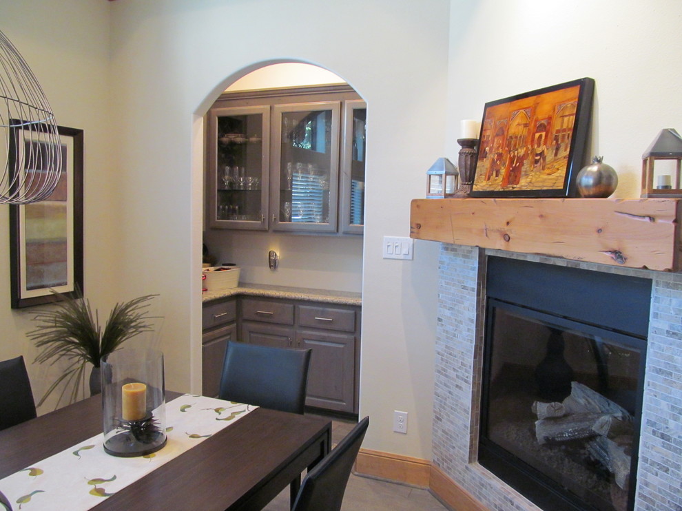 Large separate dining room in Seattle with beige walls, ceramic floors, a two-sided fireplace and a tile fireplace surround.