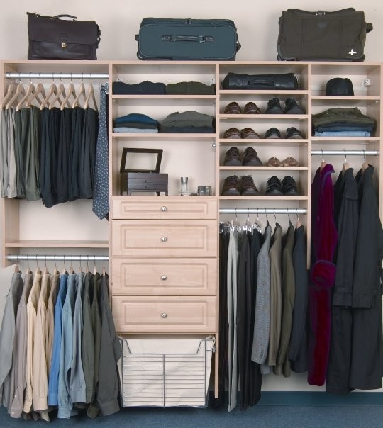 Photo of a scandinavian men's built-in wardrobe in Philadelphia with raised-panel cabinets and light wood cabinets.