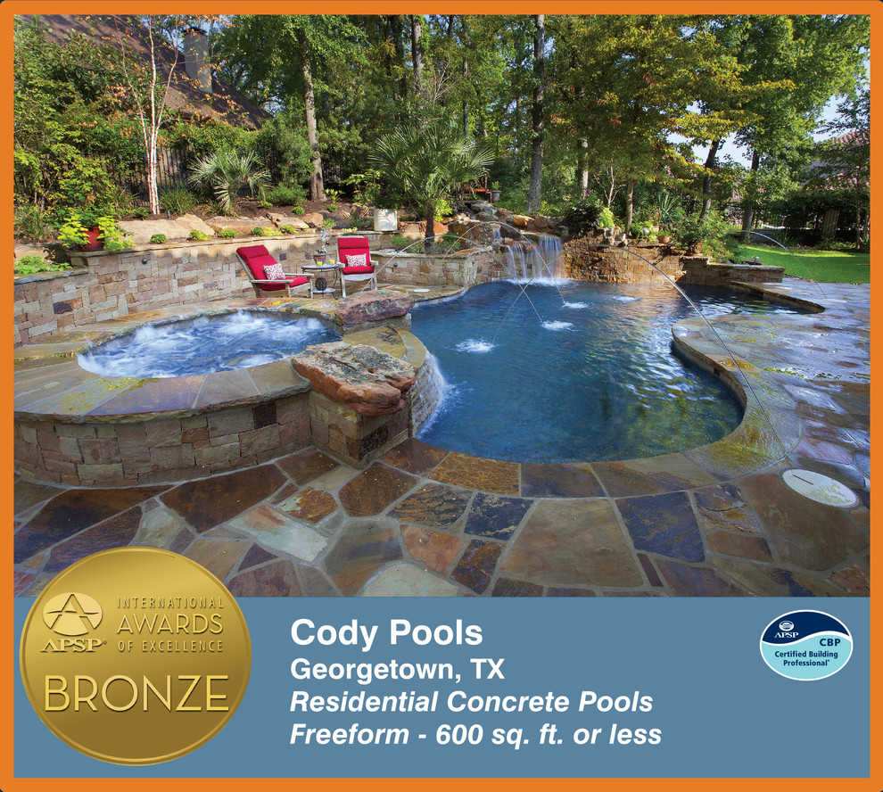 This is an example of a traditional backyard custom-shaped pool in Dallas.