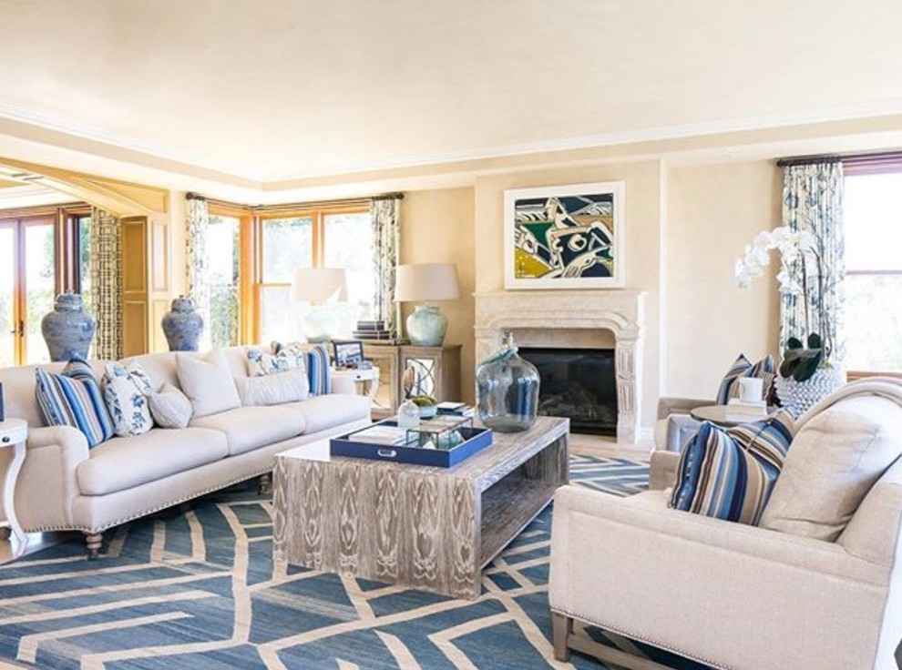 This is an example of a large contemporary enclosed living room in San Diego with white walls, carpet, a standard fireplace and a concrete fireplace surround.