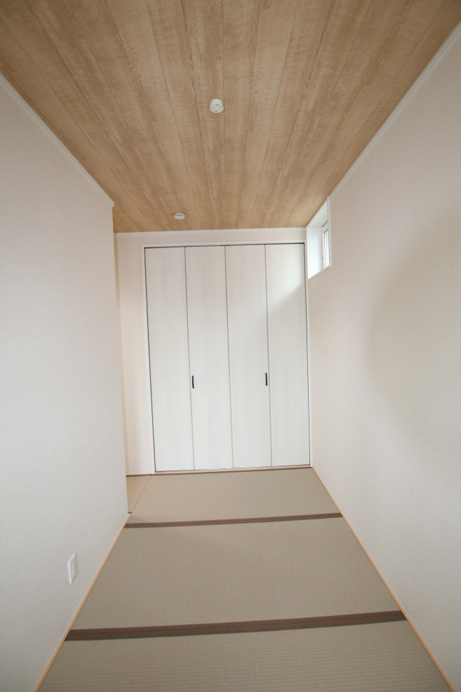 This is an example of a scandinavian master bedroom in Other with white walls, tatami floors and wood.