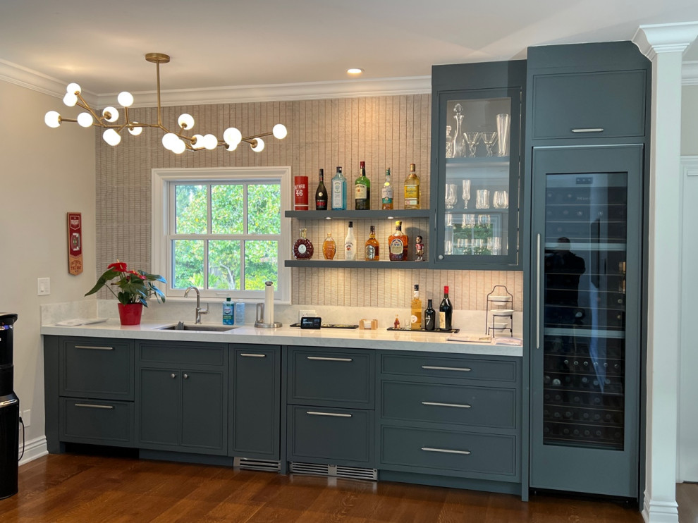 Inspiration for a mid-sized modern single-wall eat-in kitchen in San Francisco with an undermount sink, beaded inset cabinets, blue cabinets, beige splashback, shiplap splashback, stainless steel appliances, medium hardwood floors, no island, brown floor and white benchtop.