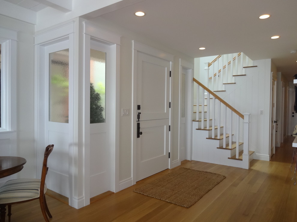 Inspiration for a mid-sized beach style foyer in Orange County with white walls, a dutch front door, a white front door, light hardwood floors, beige floor, timber and wood walls.
