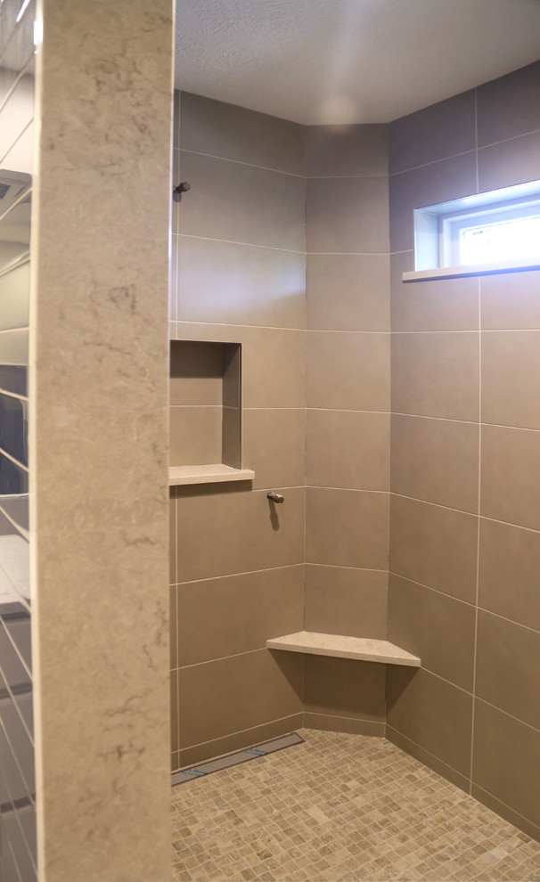 Doorless shower - mid-sized transitional master white tile and porcelain tile porcelain tile doorless shower idea with raised-panel cabinets, white cabinets, a two-piece toilet, white walls, an undermount sink and quartzite countertops