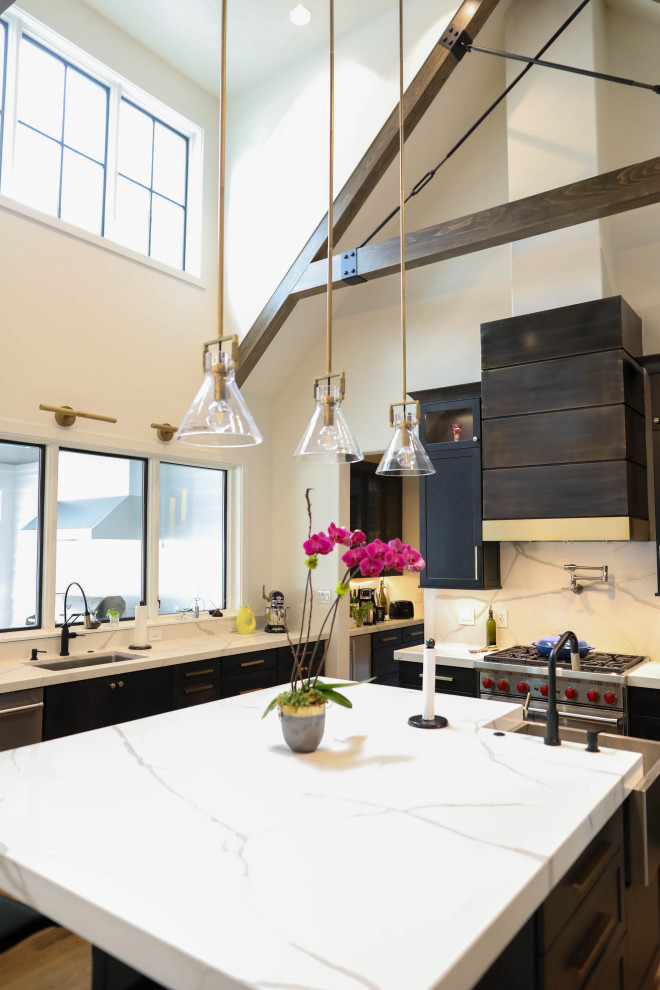 Inspiration for a large transitional u-shaped light wood floor open concept kitchen remodel with a farmhouse sink, flat-panel cabinets, dark wood cabinets, quartz countertops, white backsplash, quartz backsplash, stainless steel appliances, an island and white countertops