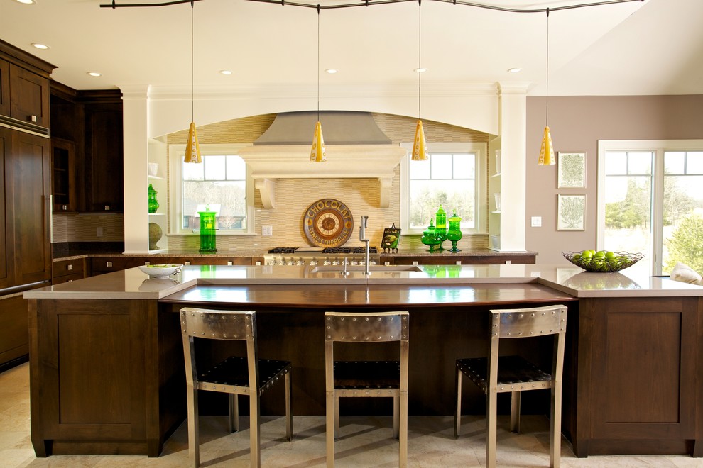 Inspiration for a transitional l-shaped travertine floor eat-in kitchen remodel in Boston with furniture-like cabinets, dark wood cabinets, concrete countertops, beige backsplash, stone tile backsplash, paneled appliances, gray walls and an island