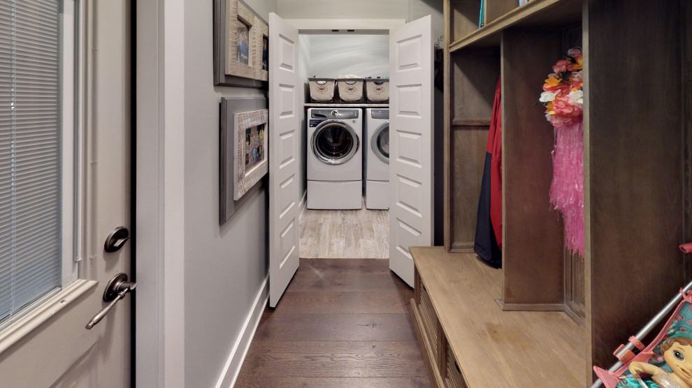 This is an example of a small single-wall dedicated laundry room with laminate benchtops, green walls, ceramic floors, a side-by-side washer and dryer, multi-coloured floor and multi-coloured benchtop.