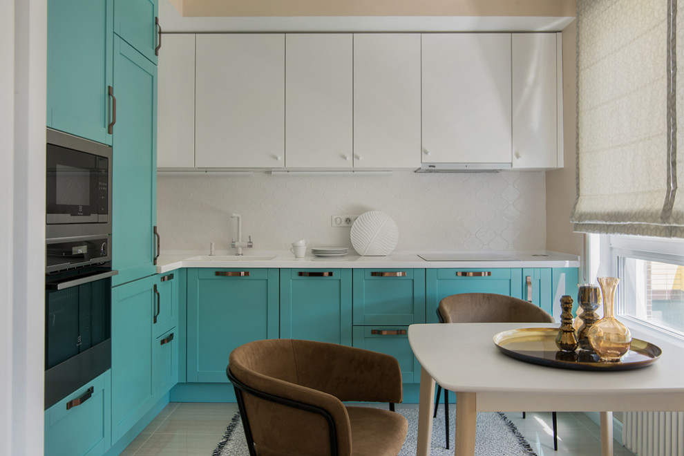 Design ideas for a mid-sized eclectic l-shaped eat-in kitchen in Moscow with an integrated sink, raised-panel cabinets, turquoise cabinets, solid surface benchtops, white splashback, ceramic splashback, stainless steel appliances, porcelain floors, no island, beige floor and white benchtop.
