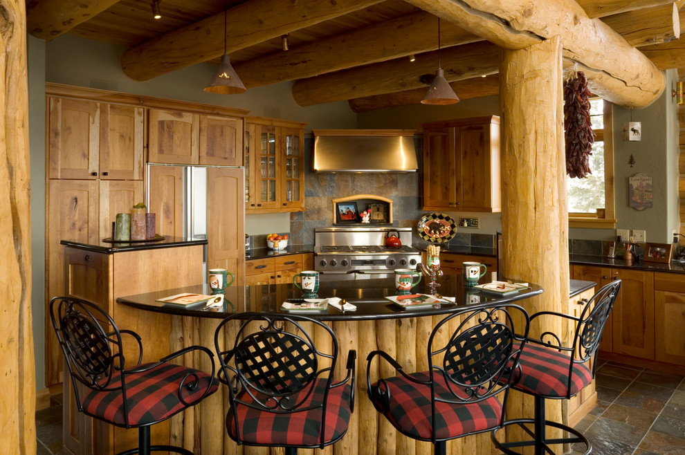 Mountain style l-shaped open concept kitchen photo with an undermount sink, shaker cabinets, medium tone wood cabinets, granite countertops, multicolored backsplash, stone tile backsplash and stainless steel appliances