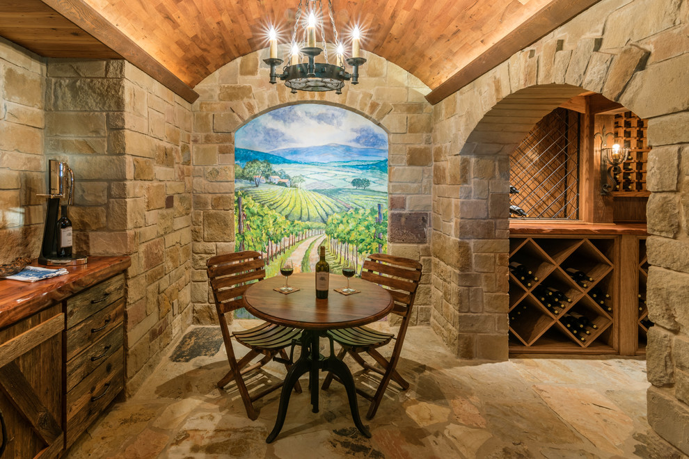 Inspiration for a mid-sized mediterranean wine cellar in Austin with limestone floors and diamond bins.