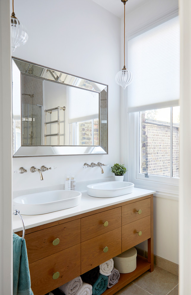 Design ideas for a transitional 3/4 bathroom in London with flat-panel cabinets, medium wood cabinets, white walls, a vessel sink, beige floor and white benchtops.