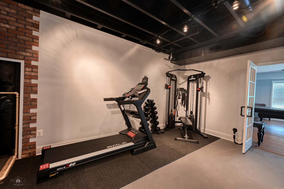 This is an example of a contemporary home gym in DC Metro with exposed beam.