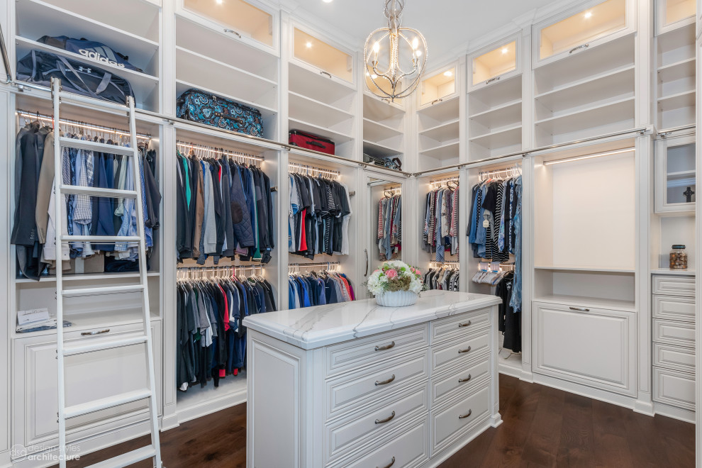 Design ideas for a large traditional gender neutral dressing room in Tampa with beaded cabinets, white cabinets, dark hardwood flooring and brown floors.