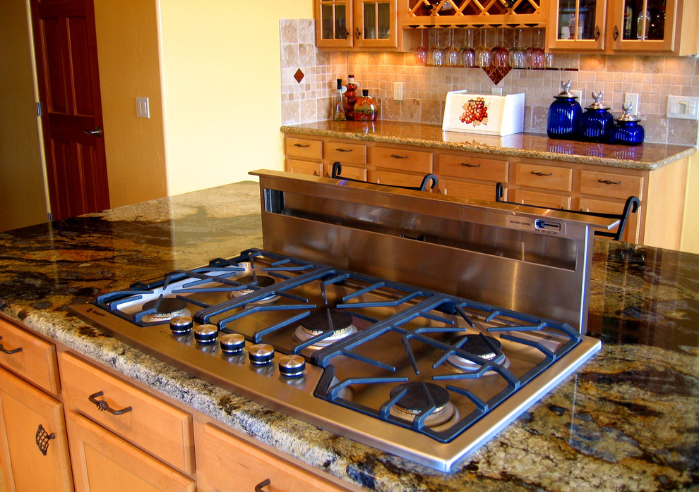 Transitional galley eat-in kitchen photo in Phoenix with an undermount sink, granite countertops, stone tile backsplash, stainless steel appliances and an island