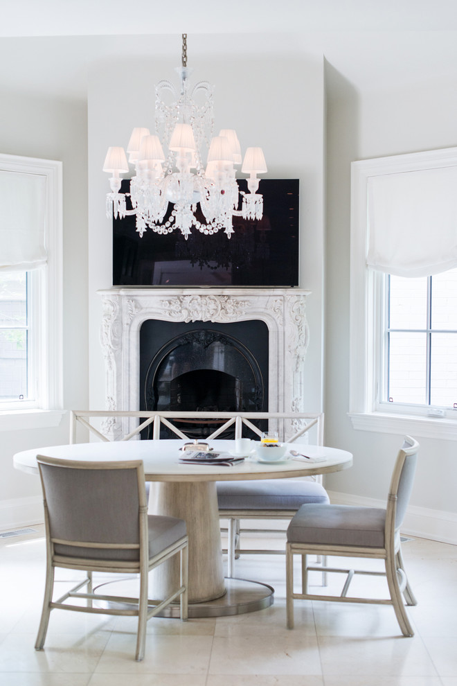 Inspiration for a transitional dining room in Toronto with white walls and a standard fireplace.
