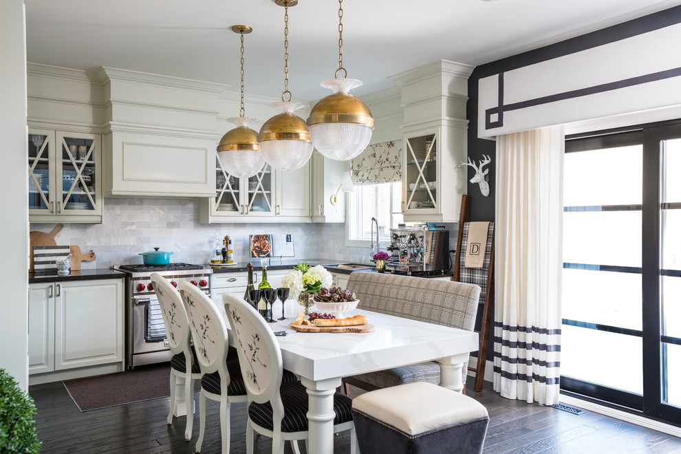 Example of a transitional l-shaped dark wood floor and brown floor eat-in kitchen design in Toronto with an undermount sink, white backsplash and stainless steel appliances