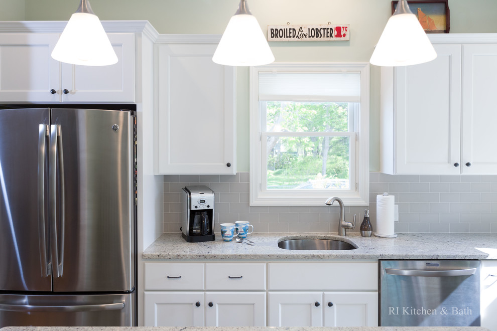 Large transitional l-shaped porcelain tile eat-in kitchen photo in Providence with an undermount sink, recessed-panel cabinets, white cabinets, granite countertops, gray backsplash, ceramic backsplash, stainless steel appliances, green walls and an island