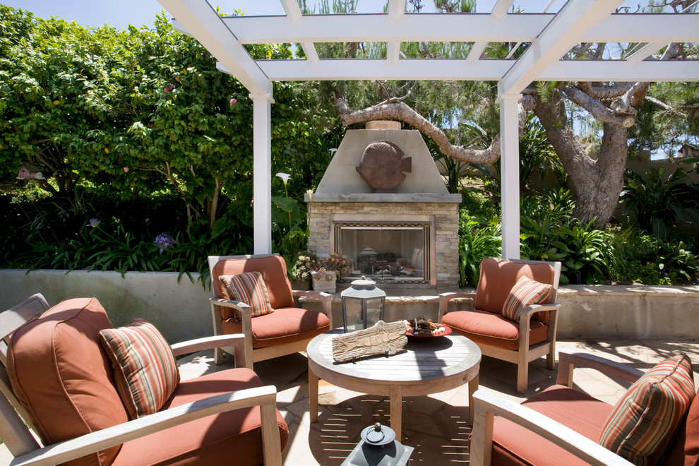 Design ideas for a traditional patio in Los Angeles with a fire feature and a pergola.