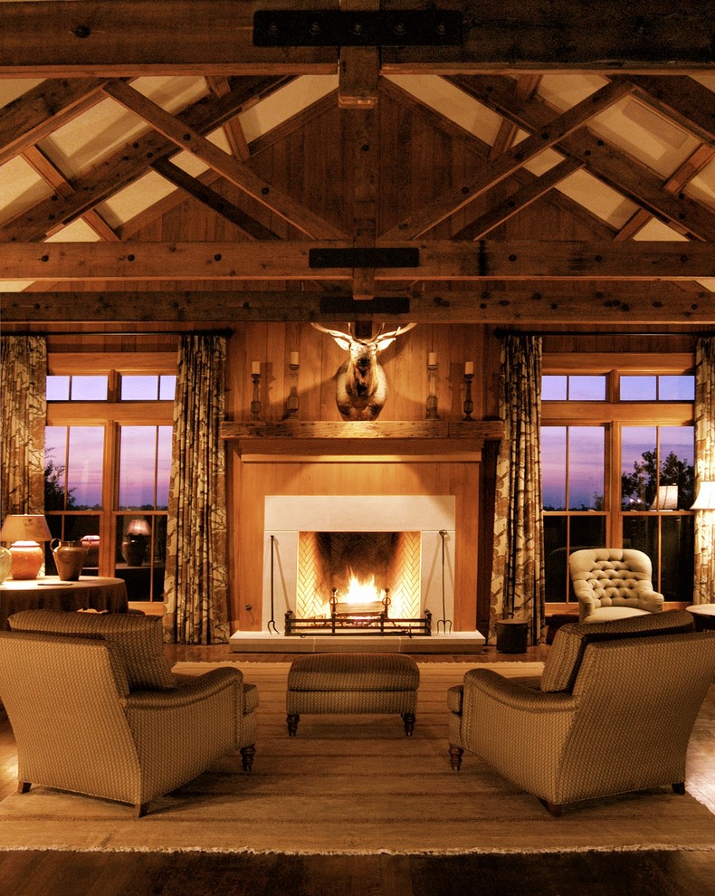 Design ideas for a large country formal open concept living room in Nashville with a standard fireplace, brown walls, dark hardwood floors, a stone fireplace surround, no tv and brown floor.