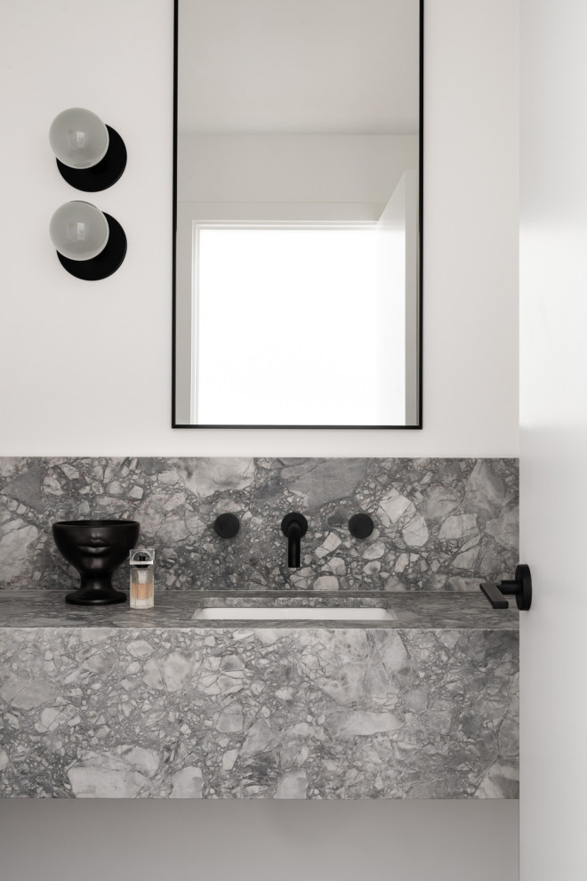 This is an example of a small contemporary powder room in Melbourne with open cabinets, grey cabinets, a one-piece toilet, white walls, marble floors, an undermount sink, marble benchtops, grey floor and grey benchtops.