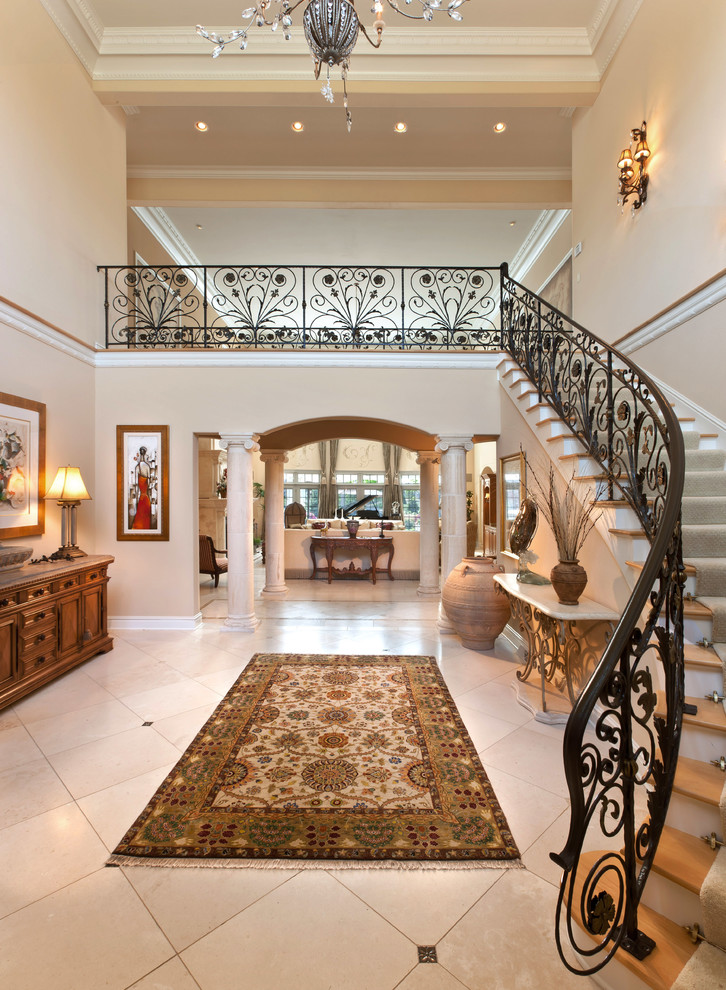 This is an example of a mediterranean foyer in Milwaukee with beige walls, ceramic floors and beige floor.