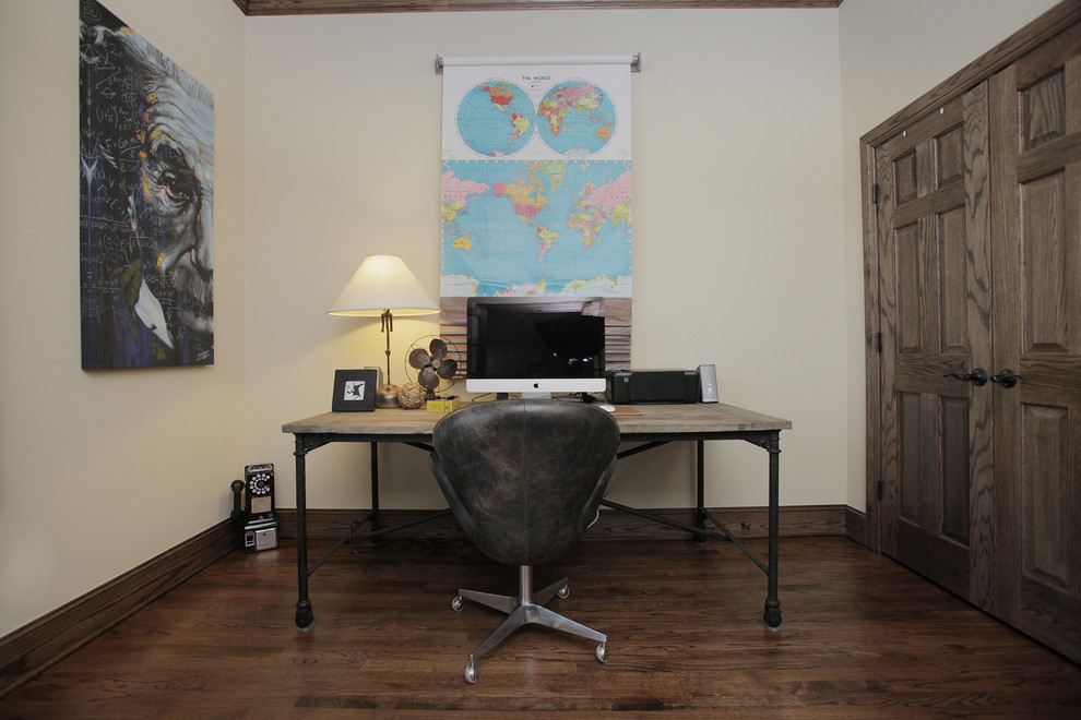 Industrial home office in Dallas with white walls, dark hardwood floors and a freestanding desk.