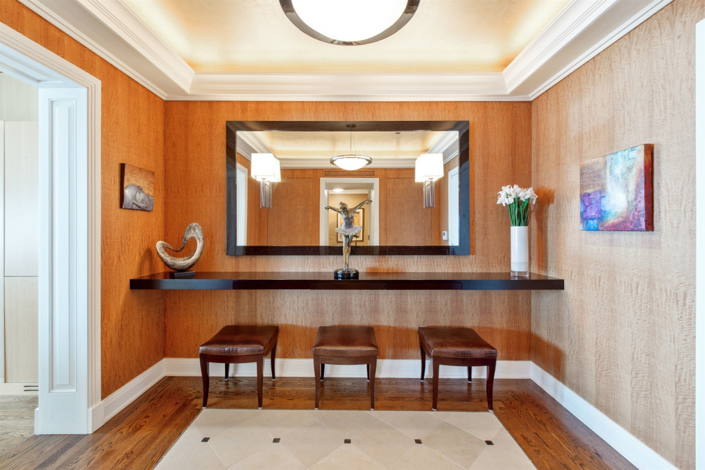 Mid-sized transitional foyer in Chicago with brown walls, limestone floors, beige floor, coffered and wood walls.