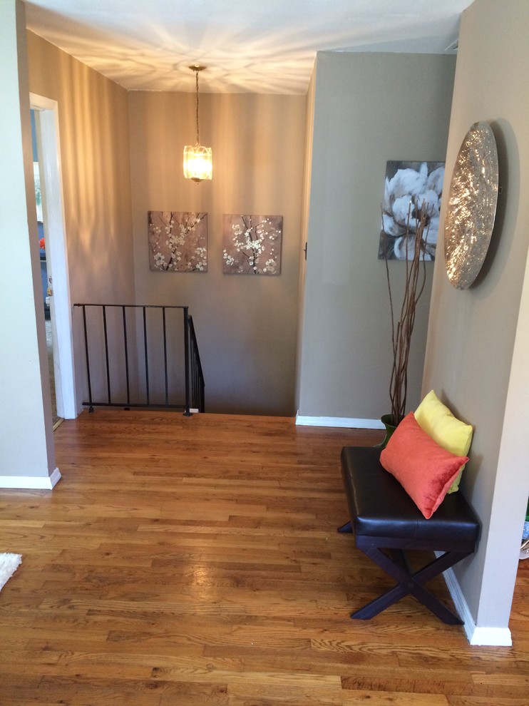 Photo of a small traditional foyer in New York with brown walls, medium hardwood floors, a single front door and a white front door.