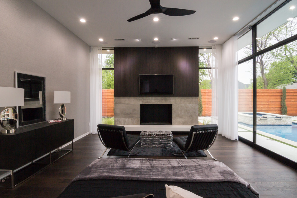 Photo of a large contemporary master bedroom in Dallas with white walls, dark hardwood floors, a standard fireplace and a wood fireplace surround.