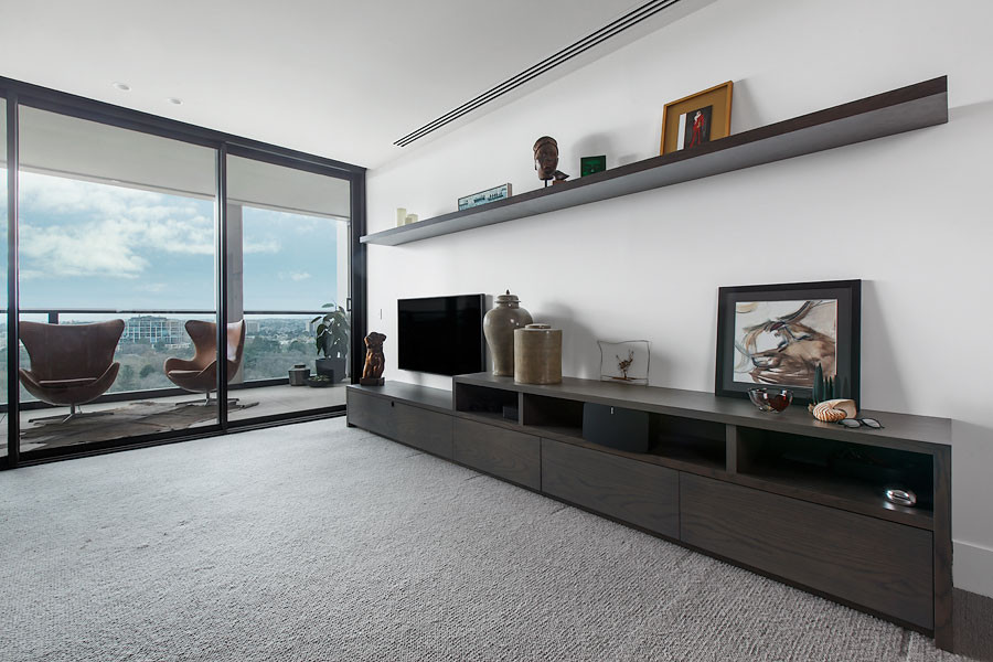 Large contemporary formal open concept living room in Melbourne with brown walls and a built-in media wall.