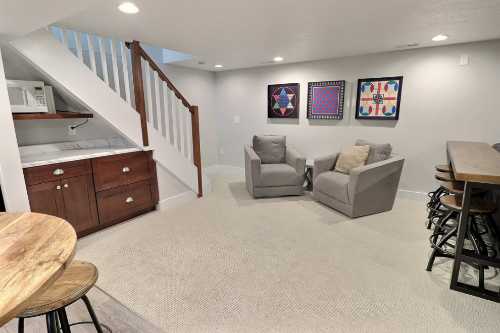 Example of a large transitional underground carpeted and beige floor basement design in Other with gray walls