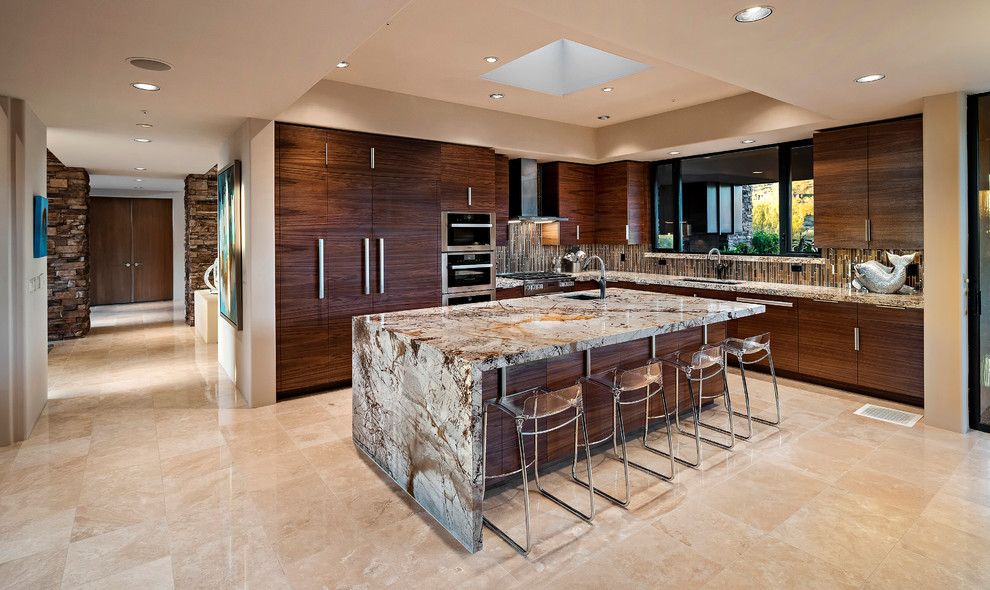 Contemporary l-shaped kitchen in Phoenix with an undermount sink, flat-panel cabinets, dark wood cabinets, multi-coloured splashback, matchstick tile splashback, panelled appliances, with island and beige floor.
