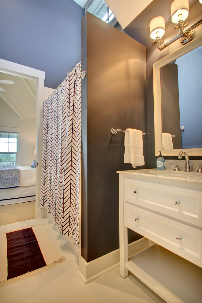 Mid-sized transitional bathroom in Jacksonville with an undermount sink, white cabinets, marble benchtops, an alcove tub, a shower/bathtub combo, white tile, porcelain tile, blue walls, ceramic floors and shaker cabinets.