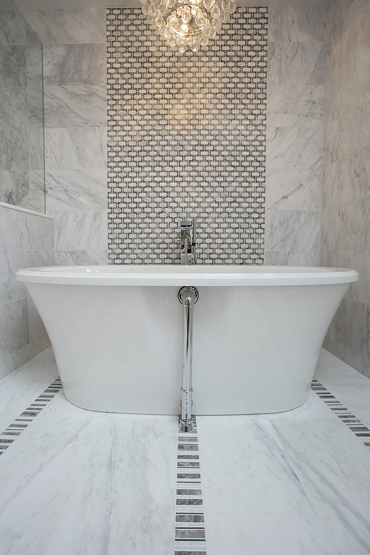 Photo of a large modern master bathroom in Vancouver with marble benchtops, a freestanding tub, a curbless shower, gray tile, mosaic tile and marble floors.