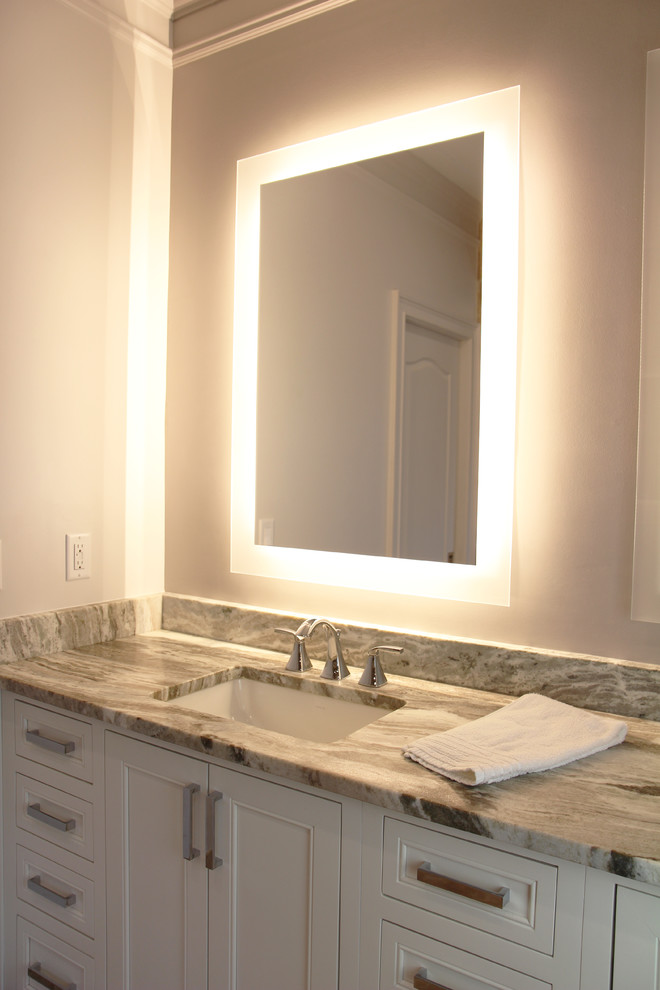 This is an example of a mid-sized transitional master bathroom in Atlanta with beaded inset cabinets, white cabinets, a two-piece toilet, beige tile, brown tile, stone tile, white walls, travertine floors, an undermount sink and quartzite benchtops.