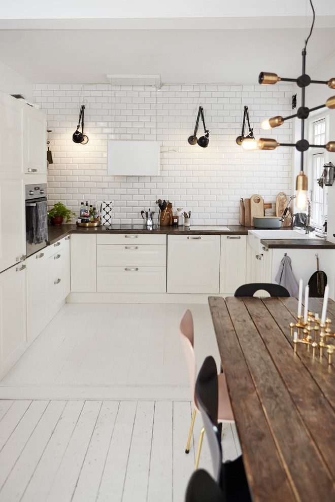 Design ideas for a large scandinavian u-shaped eat-in kitchen in Wiltshire with shaker cabinets and no island.