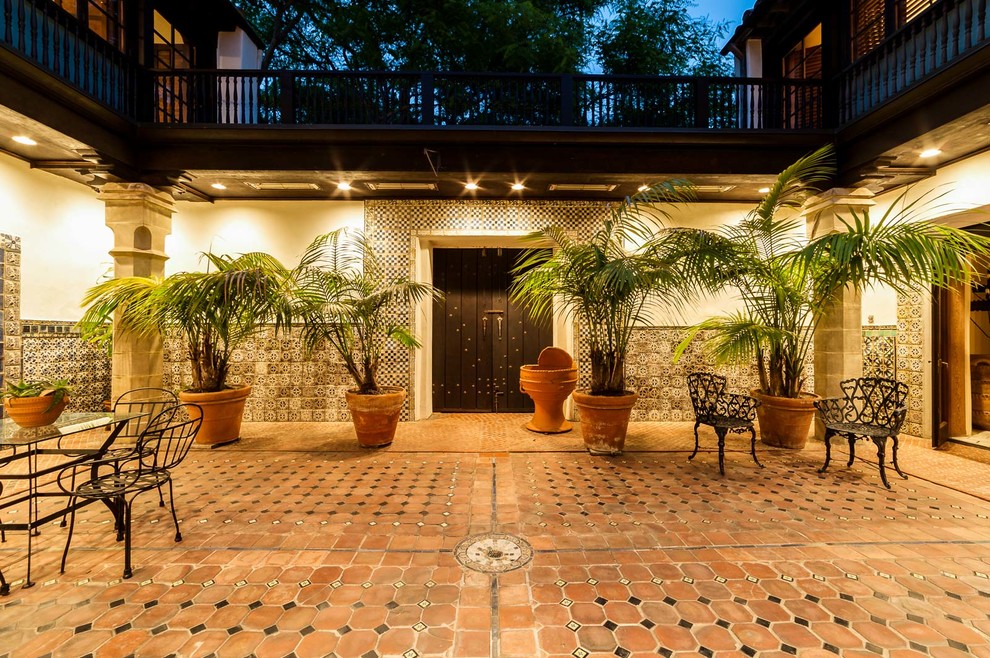 Photo of a large mediterranean courtyard patio in Los Angeles with tile and no cover.