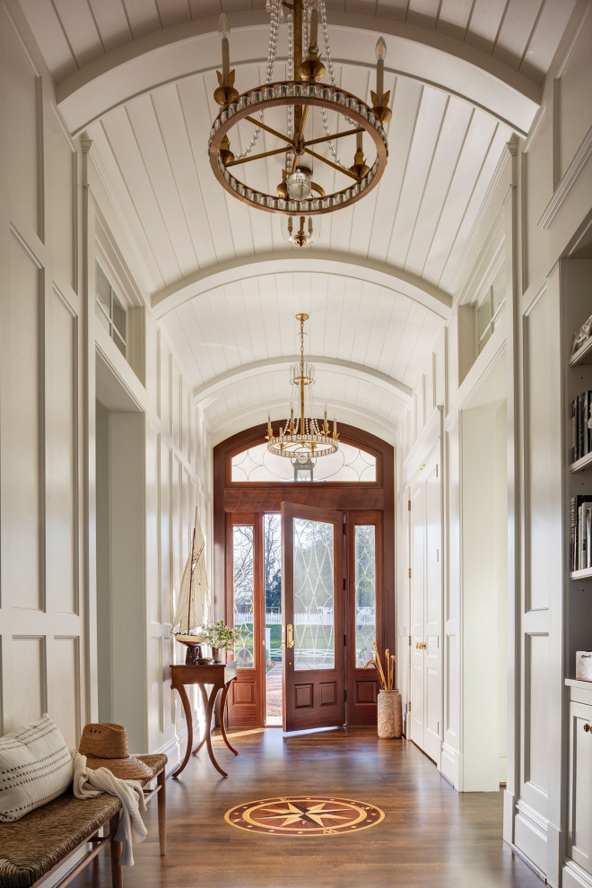 Inspiration for a beach style entryway in Baltimore with white walls, dark hardwood floors, a single front door, a glass front door, brown floor, timber, vaulted and panelled walls.
